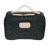Green leopard print bag with beige accents on a black background