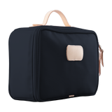 Black toiletry bag with beige accents on a white background