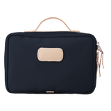 Black toiletry bag with beige handle and patch on a white background