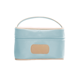 Light blue cosmetic bag with beige handle and patch on a white background