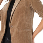 Brown corduroy blazer worn by a person on a white background