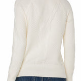 White cable knit sweater worn by a person on a white background
