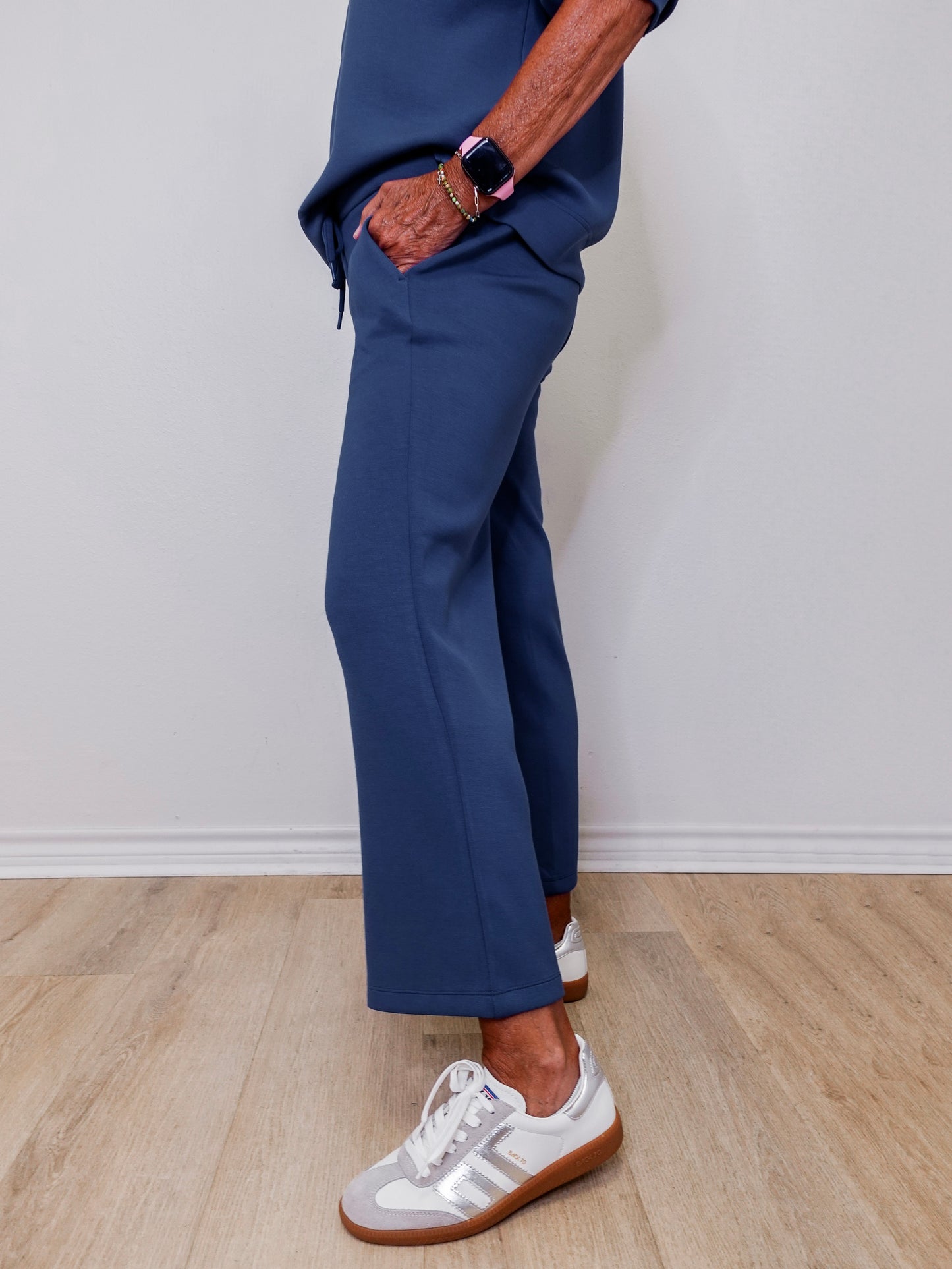 Model showcasing Liverpool pacific blue wide leg crop pull-on pants in front of white wall