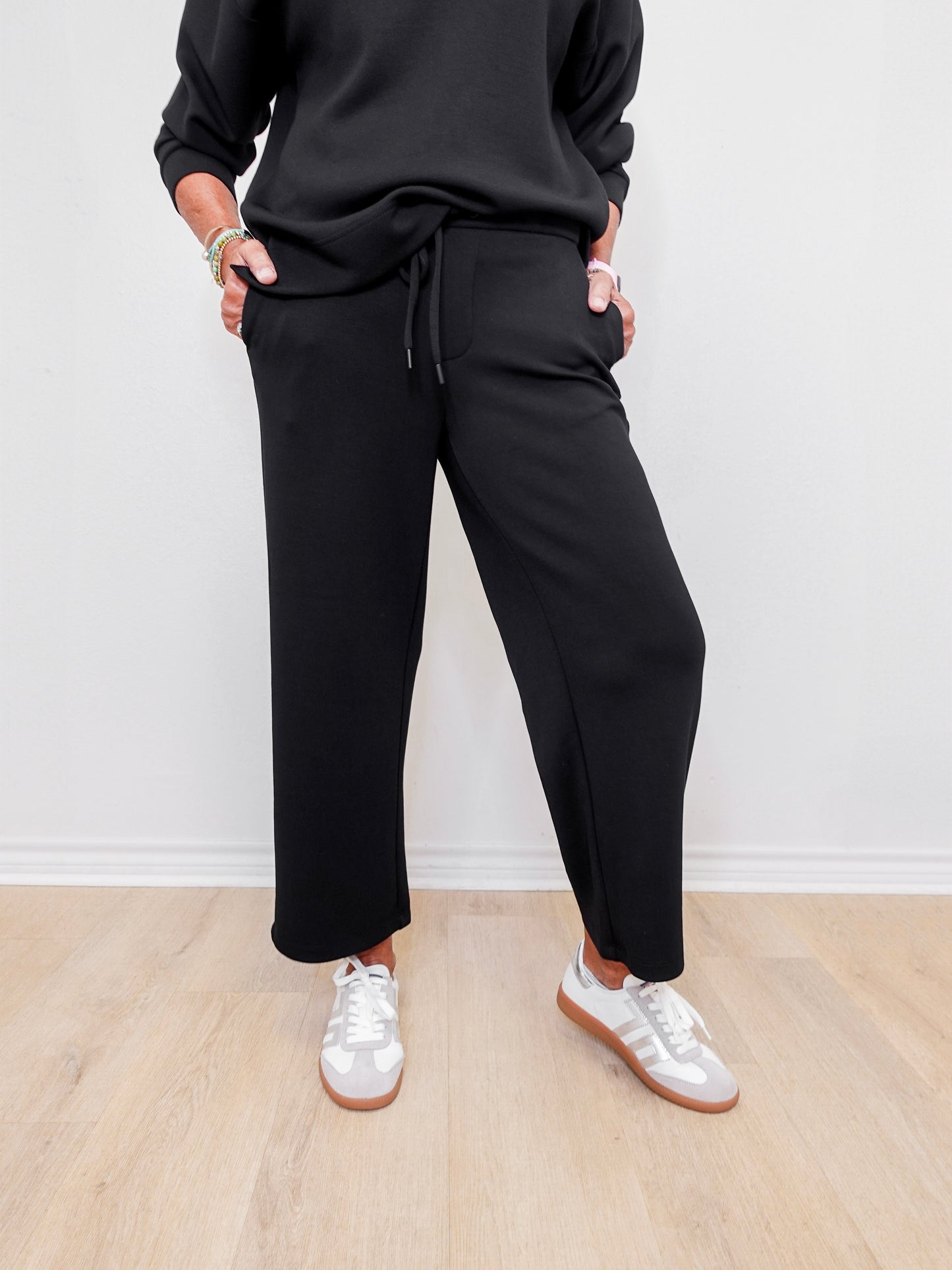 women wearing black pull on pants in the color black.