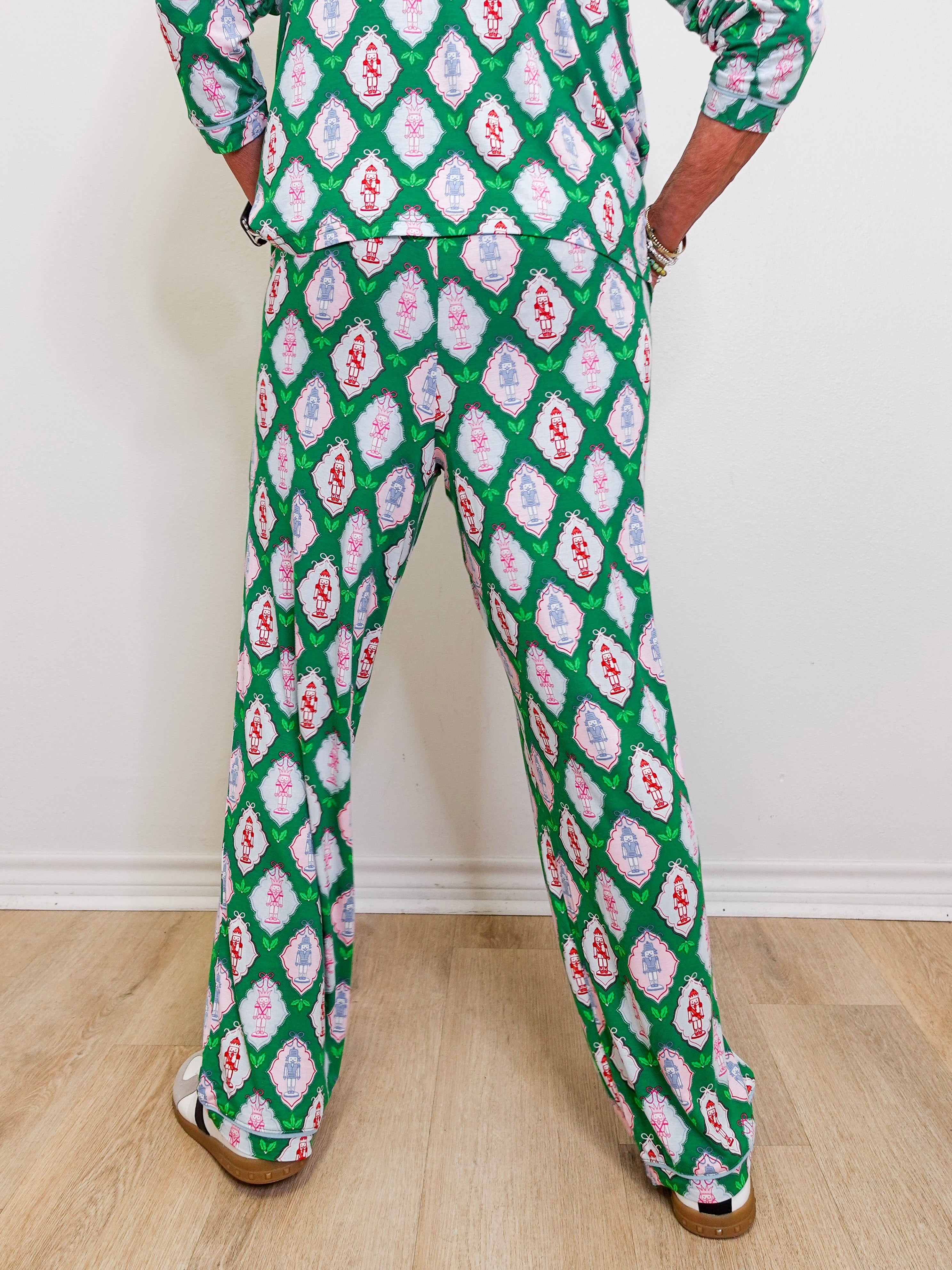 Person wearing a green patterned outfit on a plain background