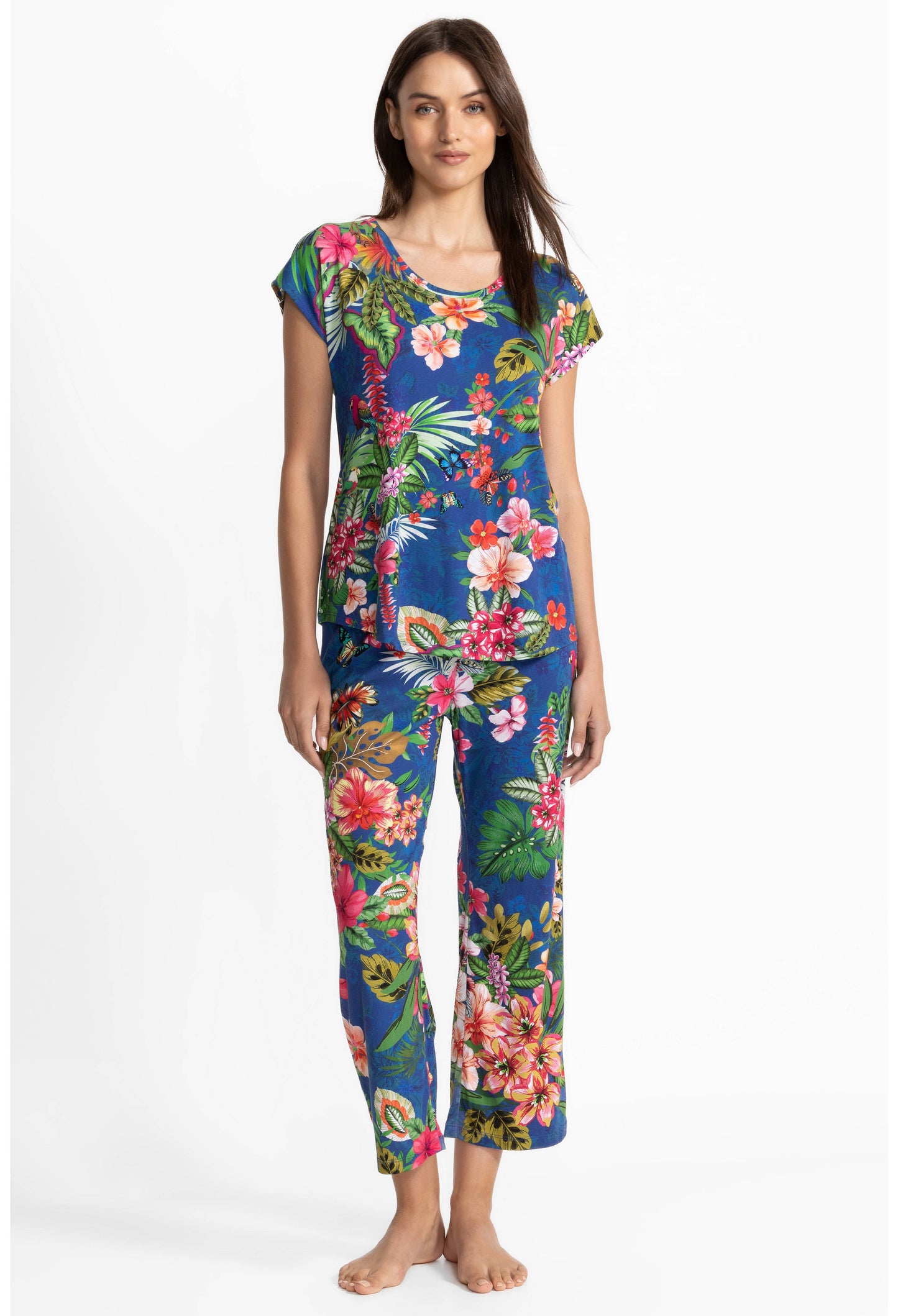 Woman wearing a colorful floral pajamas on a white background