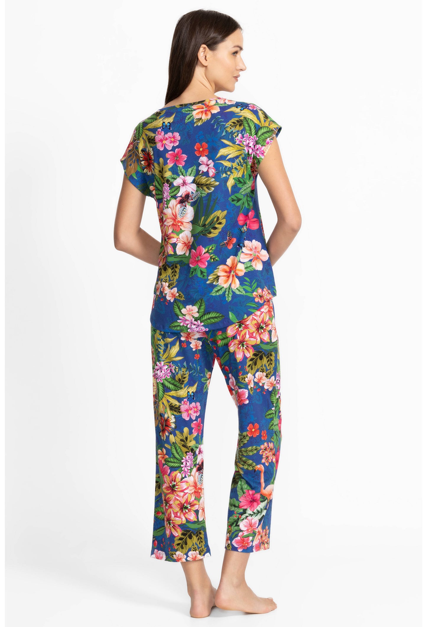 Woman wearing a colorful floral pajama on a white background