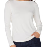 Woman wearing a white long-sleeve top and dark plaid pants on a white background