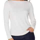 Woman wearing a white long-sleeve top and dark plaid pants on a white background