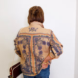 Person wearing a patterned jacket with a plain white background