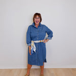 Woman wearing a blue dress with a white background