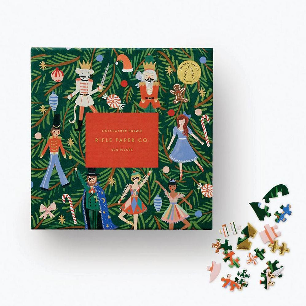Rifle Paper Co. Nutcracker puzzle box with puzzle pieces on a white background