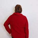 Person wearing a red jacket against a white background
