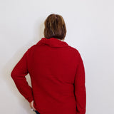 Person wearing a red jacket against a white background