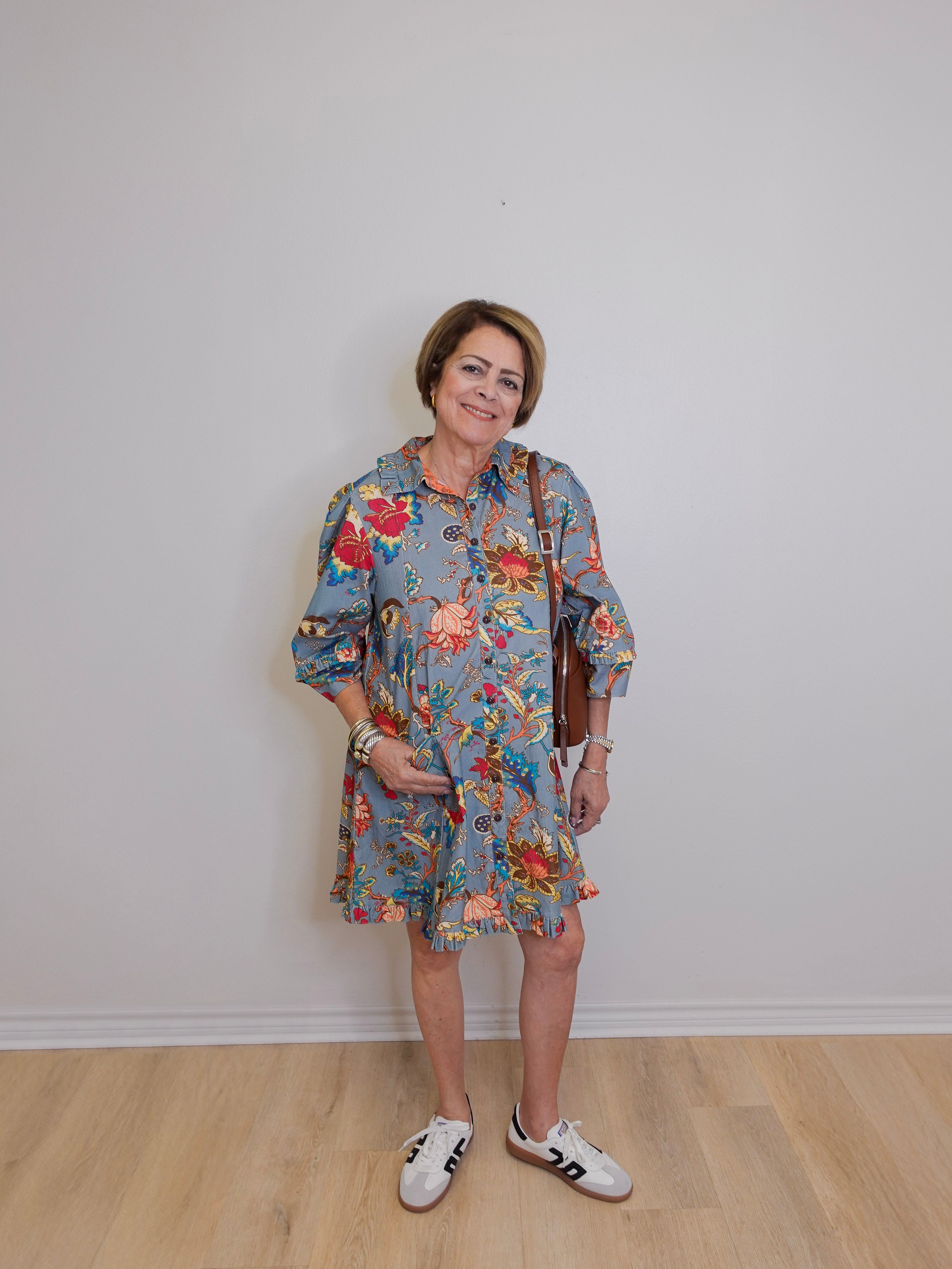 Woman wearing a floral dress with a plain background