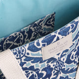 Blue and white patterned bag with a Spartina 449 tag on a beige background