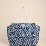 Blue patterned tote bag on a beige background