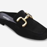 Black slip-on shoe with gold buckle on a white background