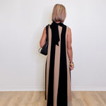 Woman wearing a versatile sleeveless colorblock maxi dress for women against a white background.