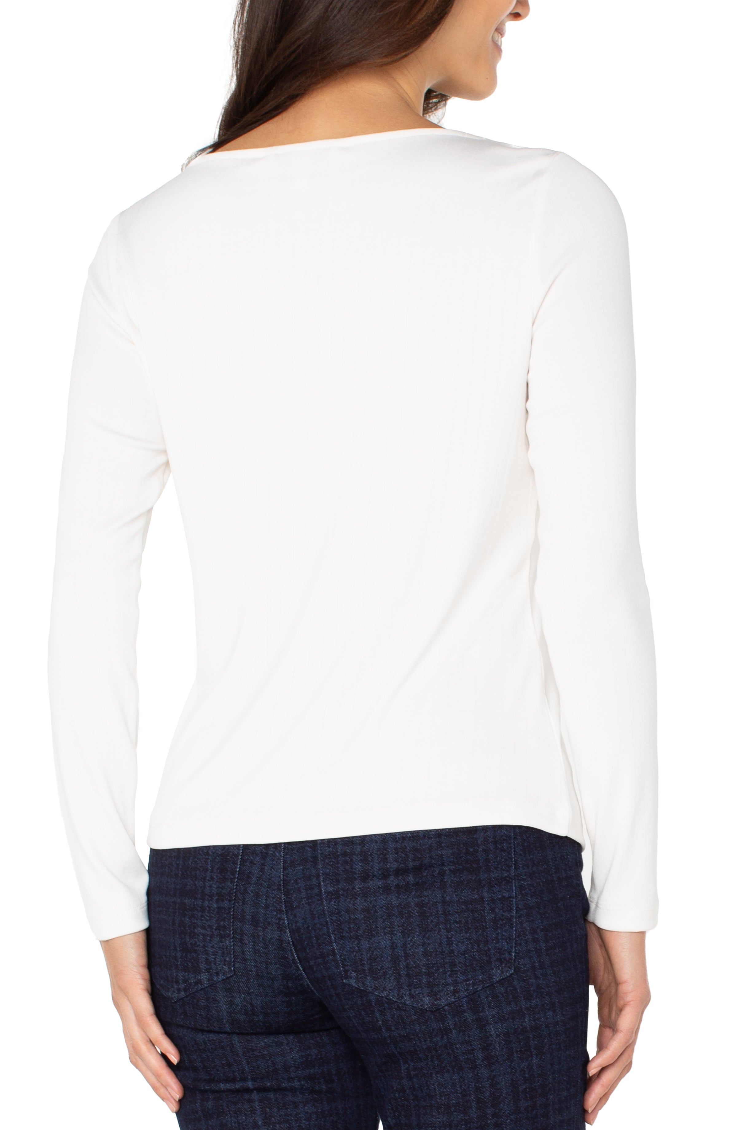 White long-sleeve top worn by a person on a white background
