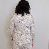 Person wearing a leopard print pajama set against a plain background