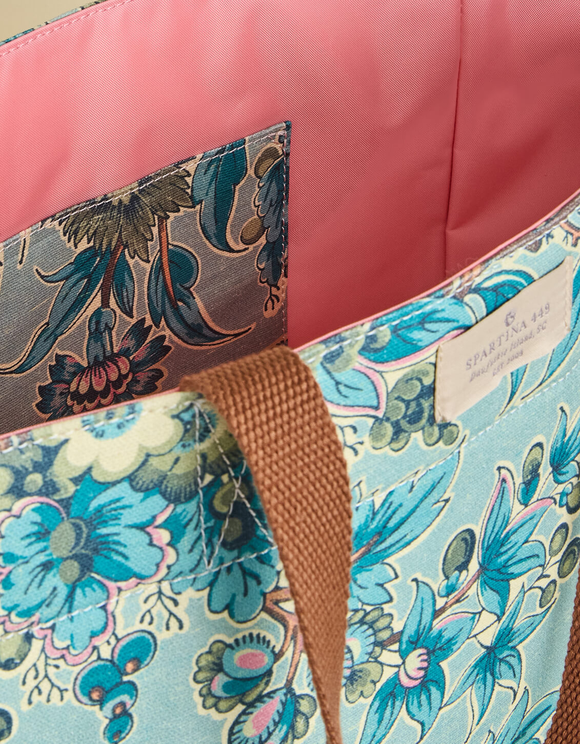 Close-up of a floral-patterned bag with a visible brand label.