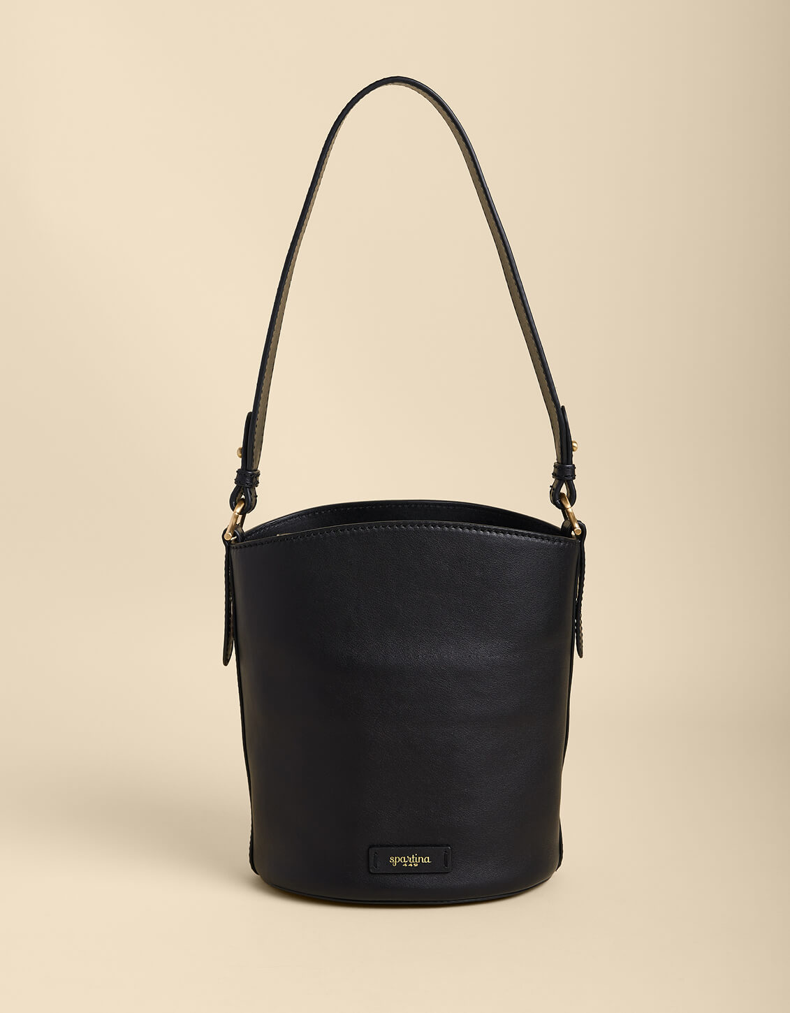 Black bucket bag on a beige background