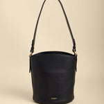 Black bucket bag on a beige background