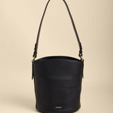 Black bucket bag on a beige background