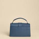 Blue handbag on a beige background