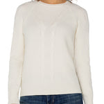 Woman wearing a white sweater and blue jeans on a white background