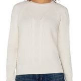 Woman wearing a white sweater and blue jeans on a white background