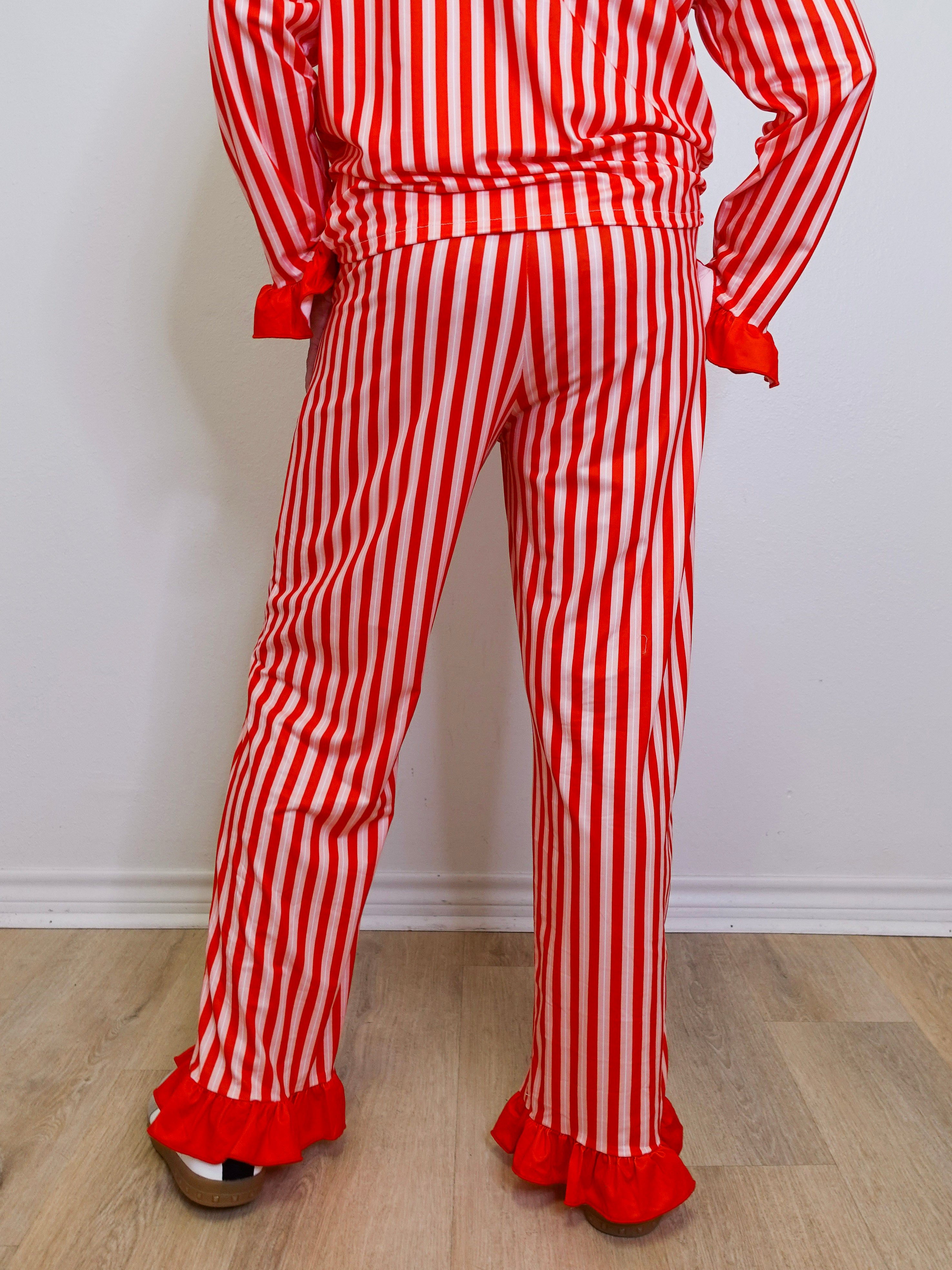 Red and white striped outfit with ruffled pants on a plain background