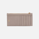 Beige cardholder with gold zipper on a light beige background