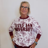Person wearing a Texas A&M University sweatshirt against a plain background