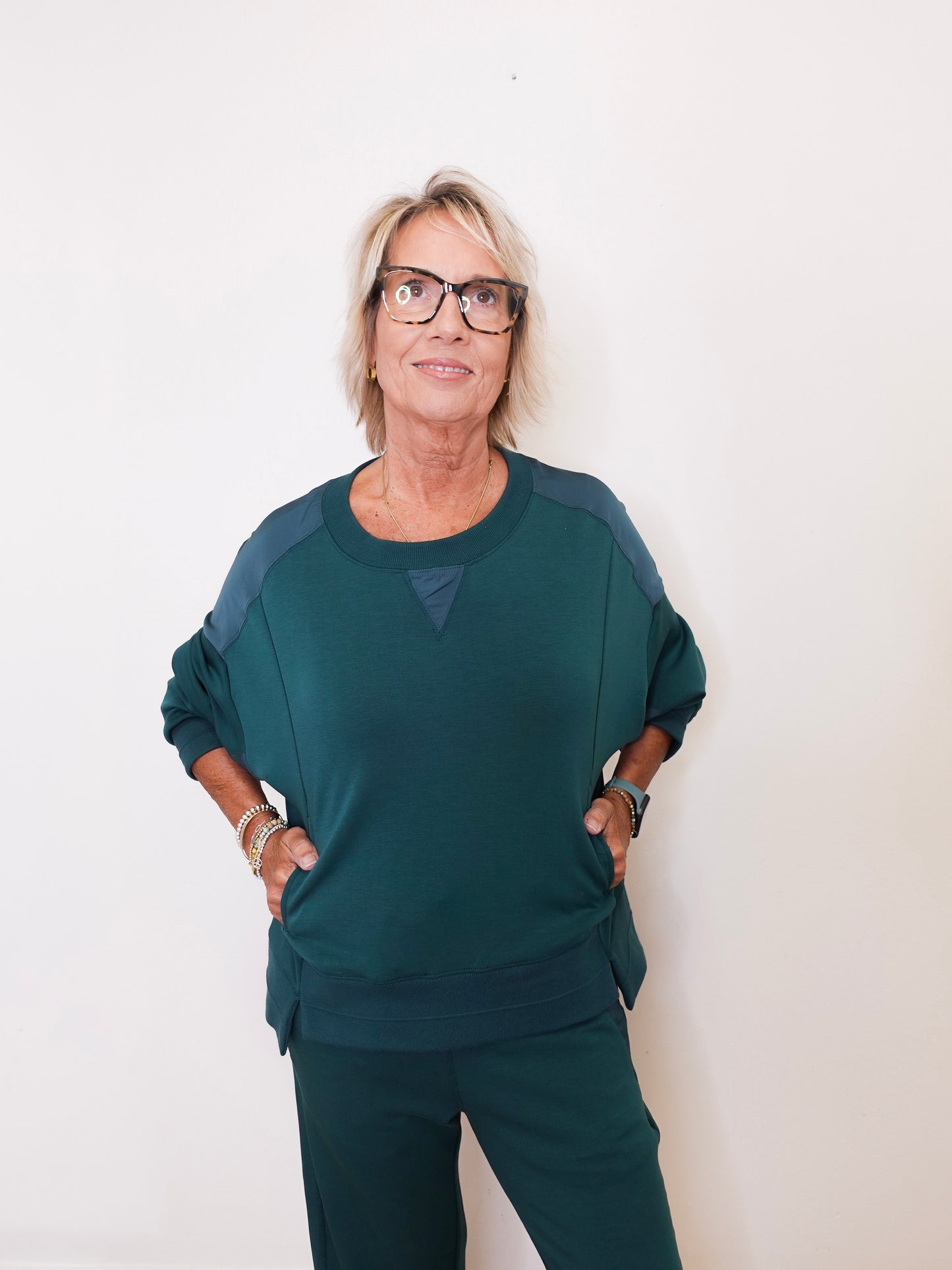 Woman wearing a green outfit against a white background
