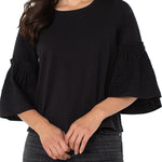 Woman wearing a black blouse with ruffled sleeves on a white background