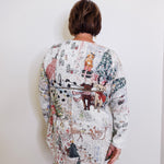 Person wearing a long, patterned sweater against a white background