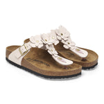 Pair of sandals with white flowers on a white background