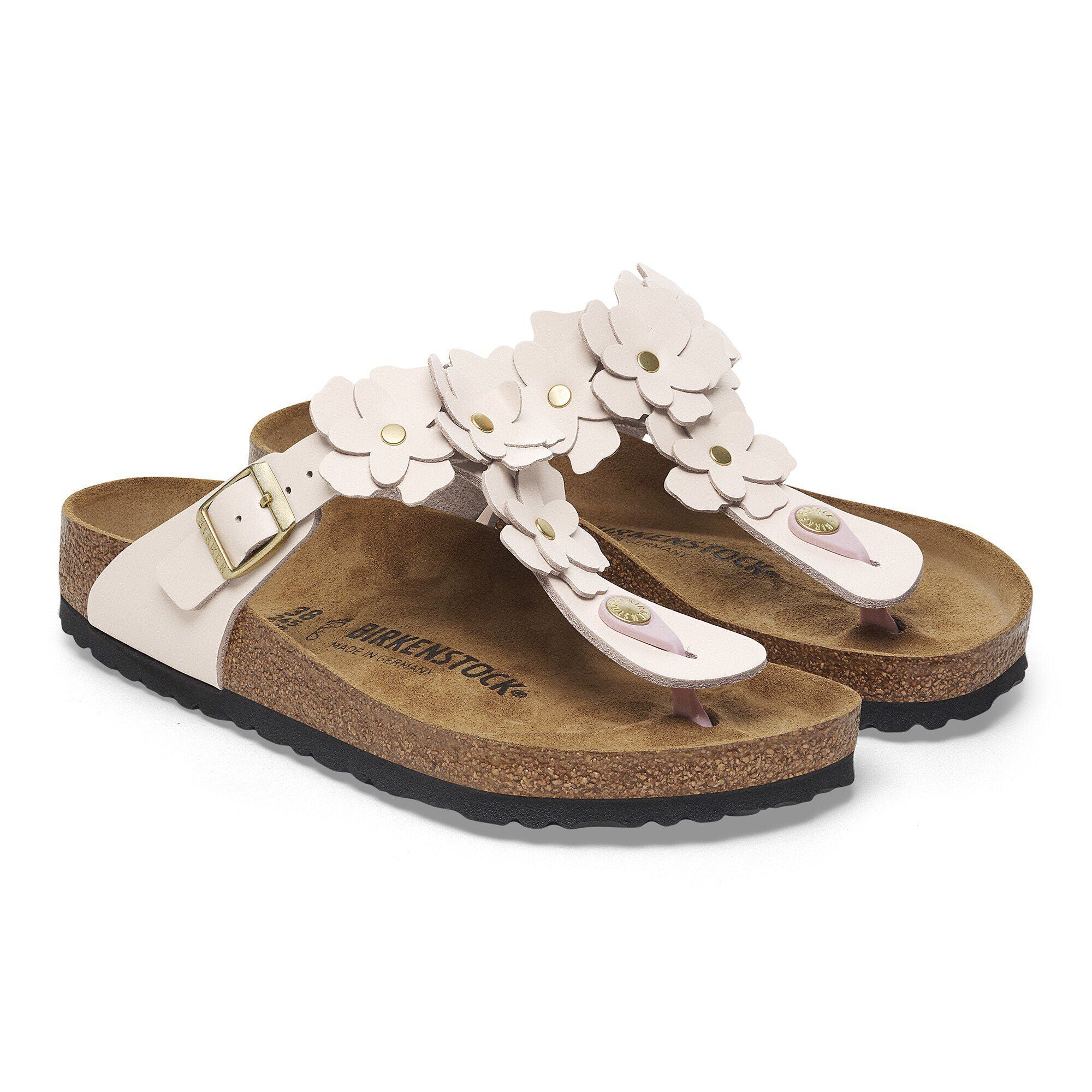 Pair of sandals with white flowers on a white background