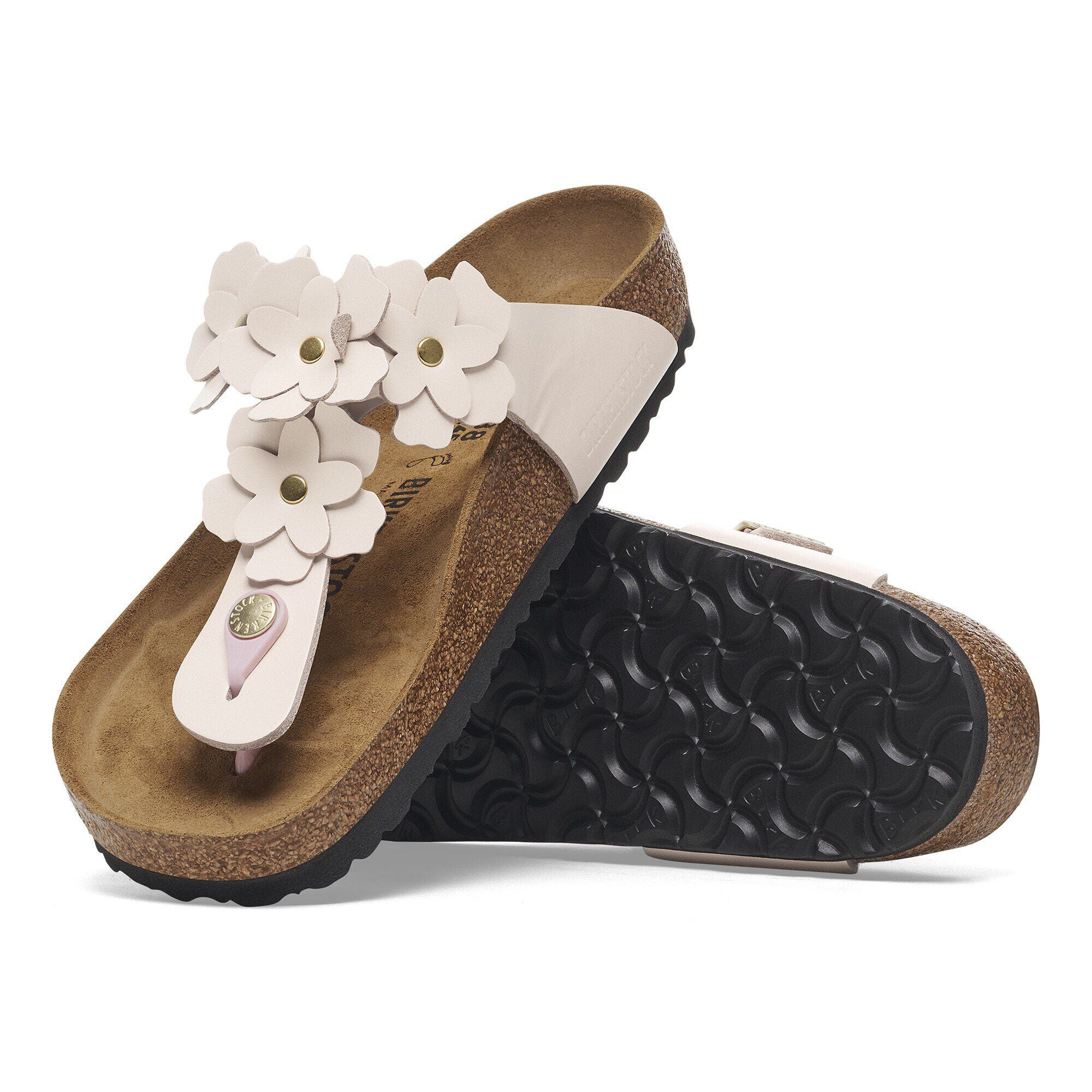 Pair of sandals with white floral decorations on a white background