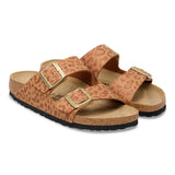 Pair of leopard print sandals with gold buckles on a white background