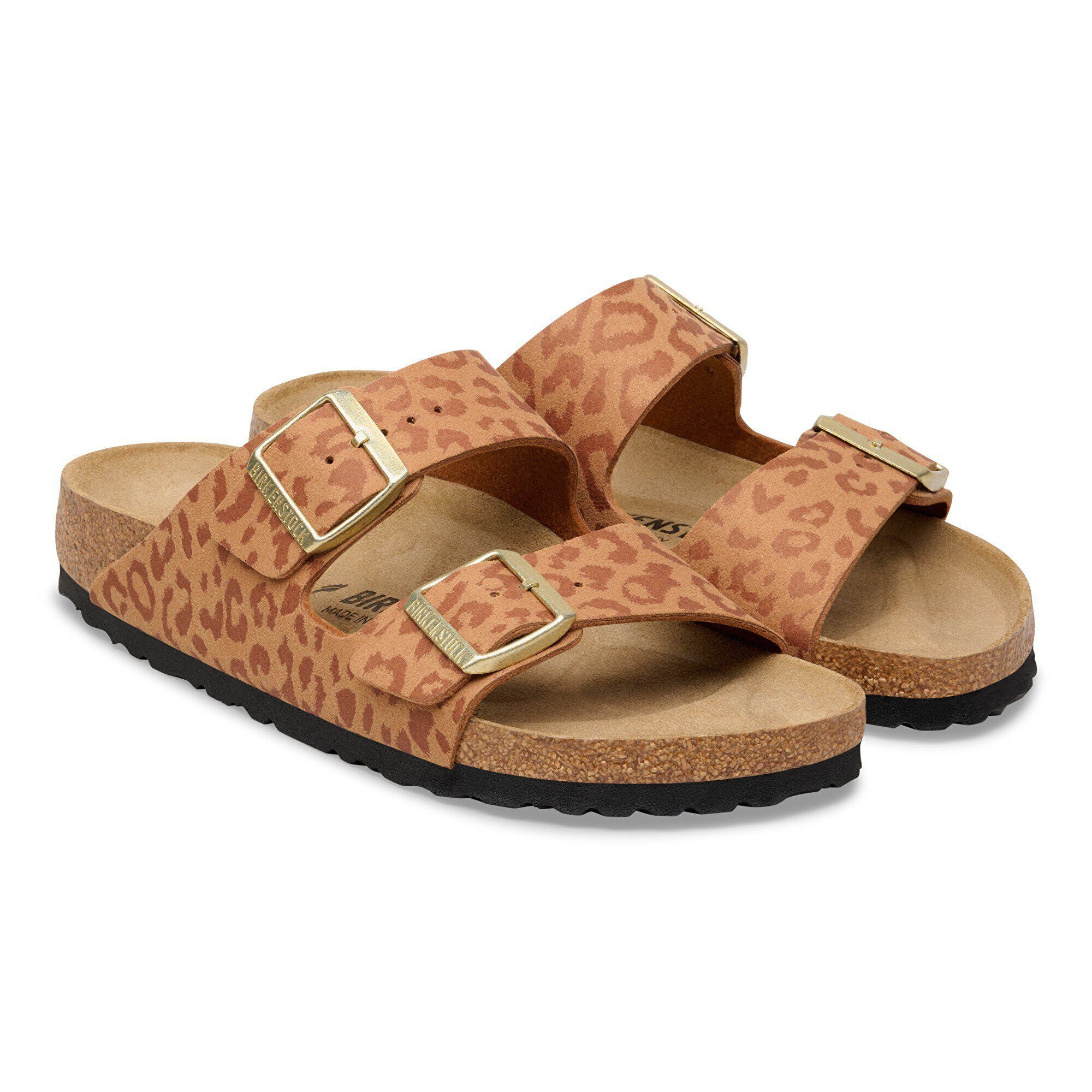 Pair of leopard print sandals with gold buckles on a white background