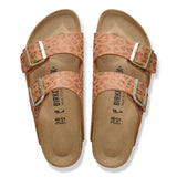 Pair of leopard print sandals with gold buckles on a white background