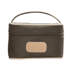 brown cosmetic bag with beige handle and patch on a white background