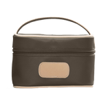 brown cosmetic bag with beige handle and patch on a white background