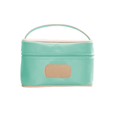 mint cosmetic bag with beige handle and patch on a white background