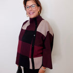 Woman wearing a checkered sweater against a white background