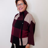 Woman wearing a checkered sweater against a white background