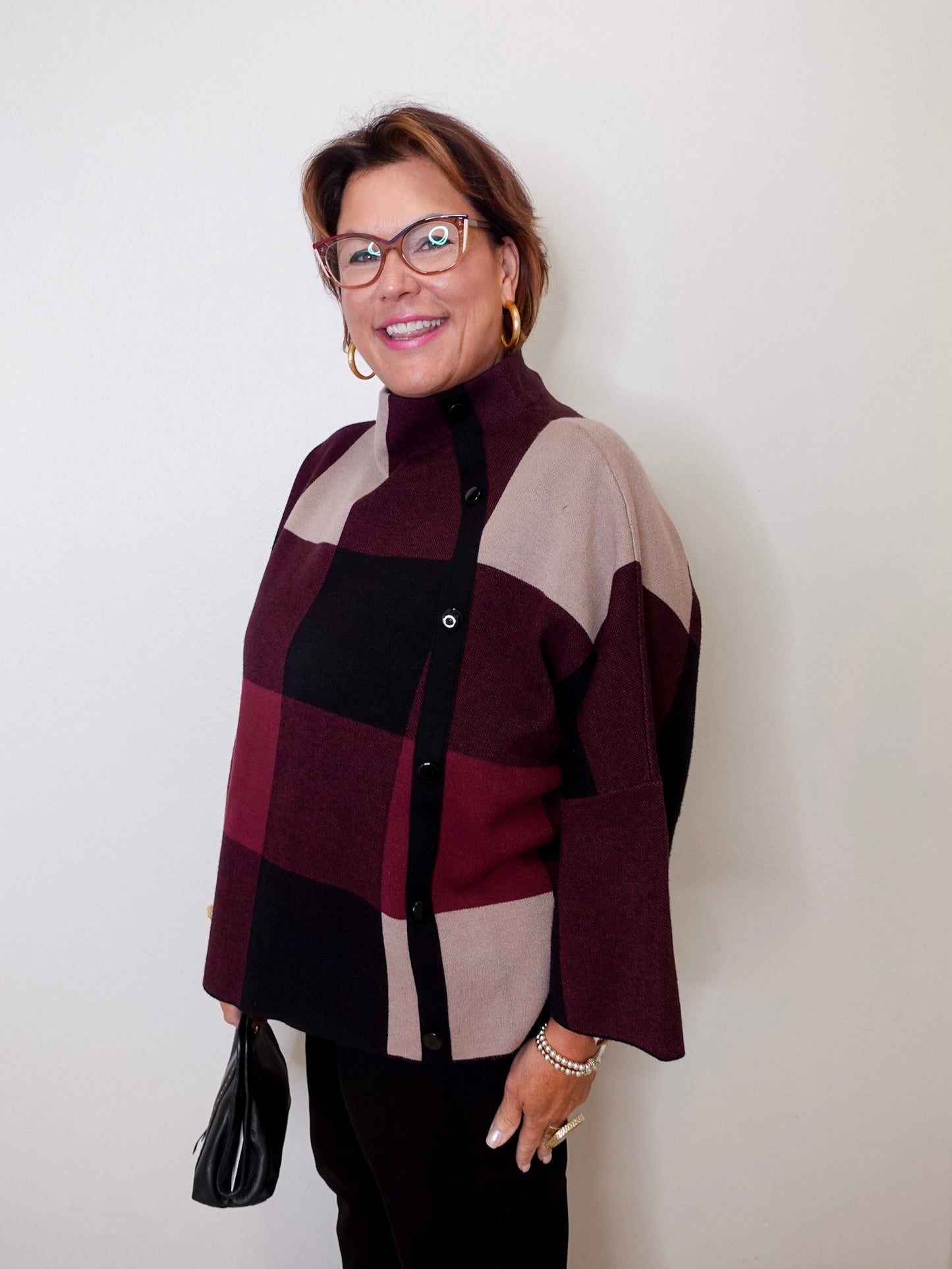 Woman wearing a checkered sweater against a white background